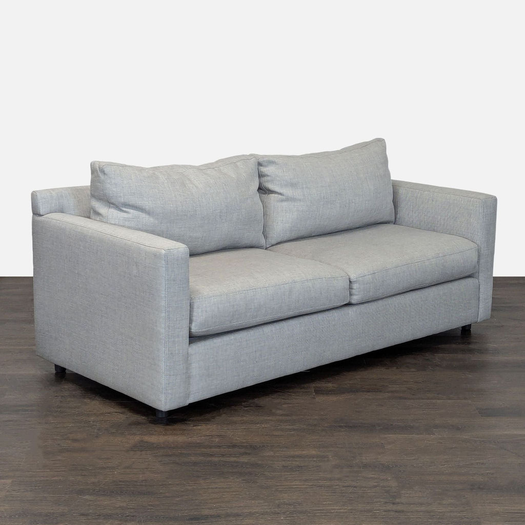 Modern Crate & Barrel loveseat in soft gray fabric; features supportive cushions and minimal, clean-lined arms.