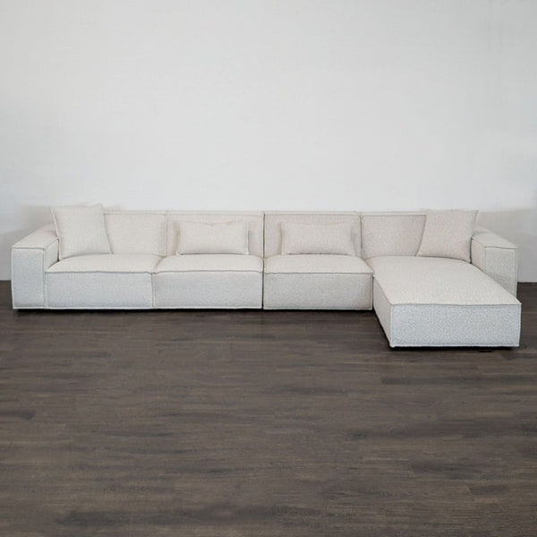 Modern Rove Concepts sectional with right-facing chaise, boucle fabric, wide arms, and accent pillows.
