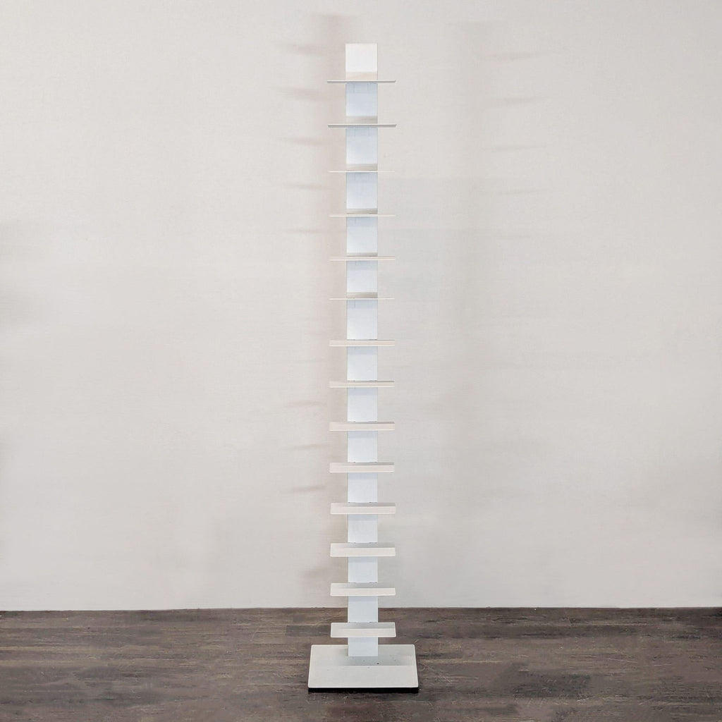 Slim white Bruno Rainaldi bookshelf with multiple shelves, perfect for modern small spaces.  
