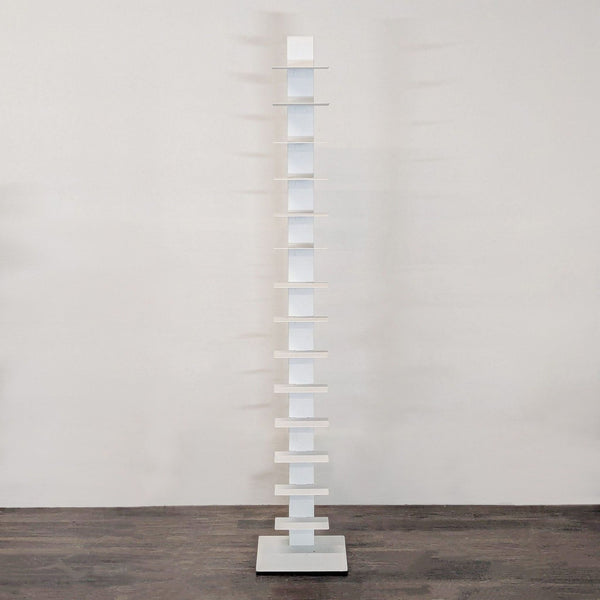 Slim white Bruno Rainaldi bookshelf with multiple shelves, perfect for modern small spaces.  