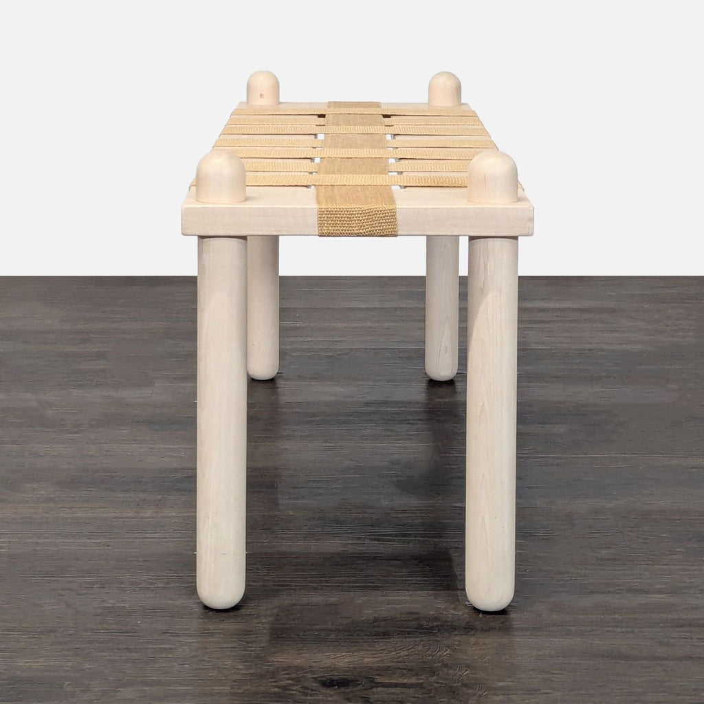 1. Modern ottoman by küdd:krig HOME featuring a minimalist design and neutral upholstery, ideal for living spaces.