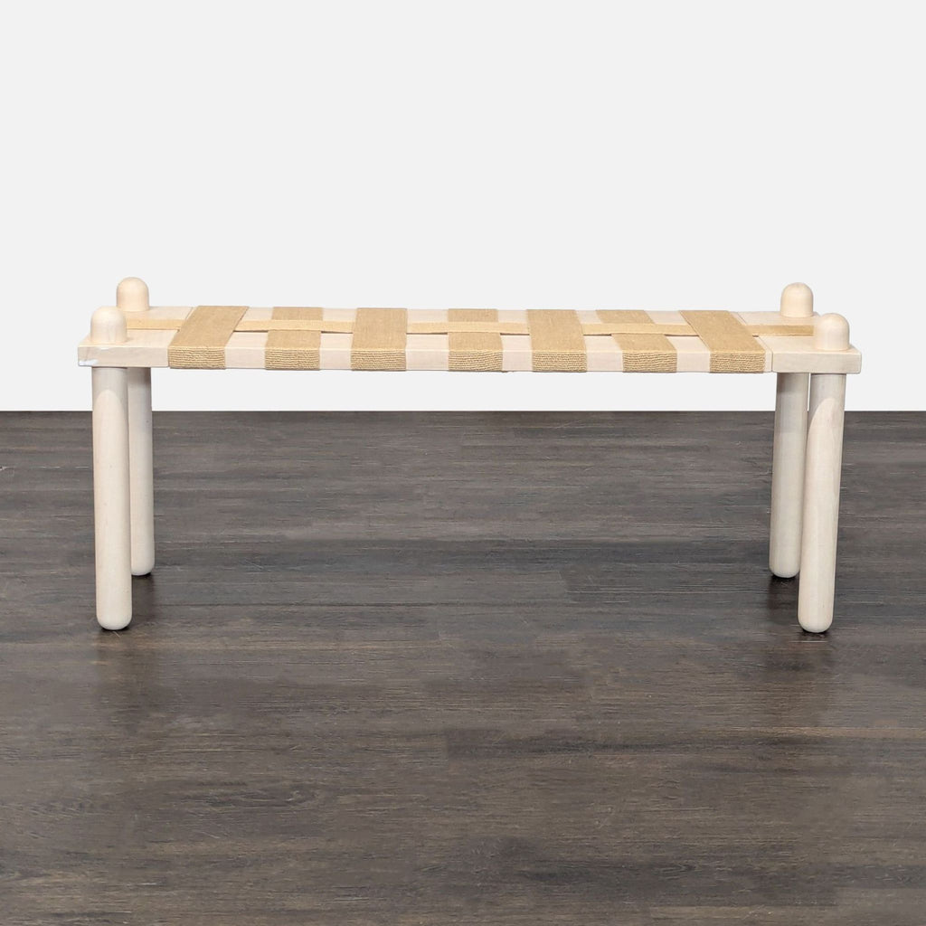 2. Plush upholstered stool from küdd:krig HOME, perfect as extra seating or a footrest in contemporary interiors.