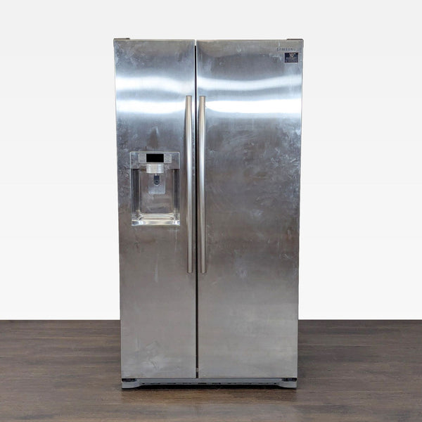 Samsung side-by-side refrigerator in stainless steel with water and ice dispenser, some visible surface marks.