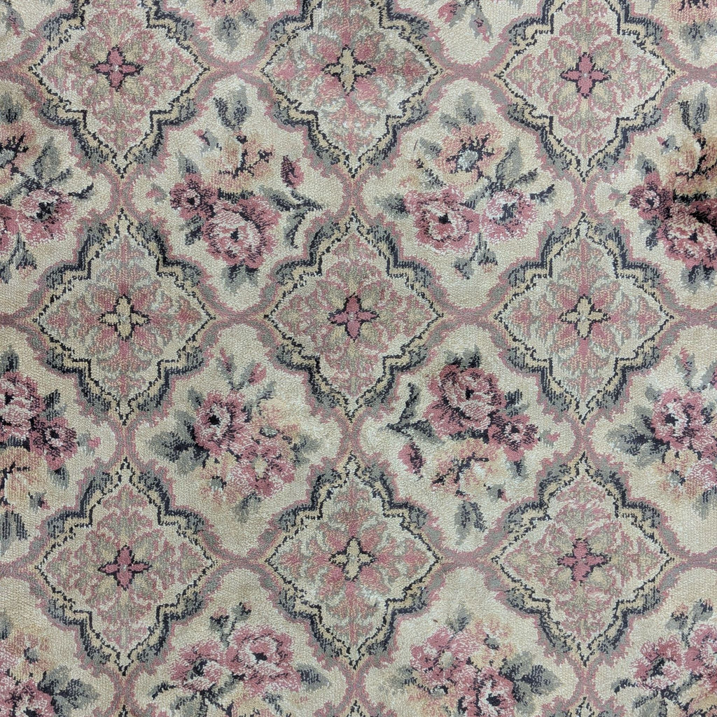 Classic floral rug with soft colors and fringe, ideal for adding elegance and charm to various room decors.