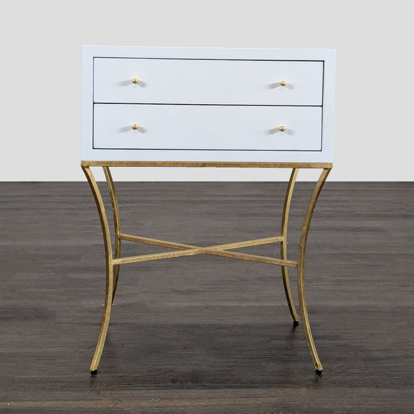 1. White Worlds Away end table with two drawers and gold metal base, shown on a dark wood floor.