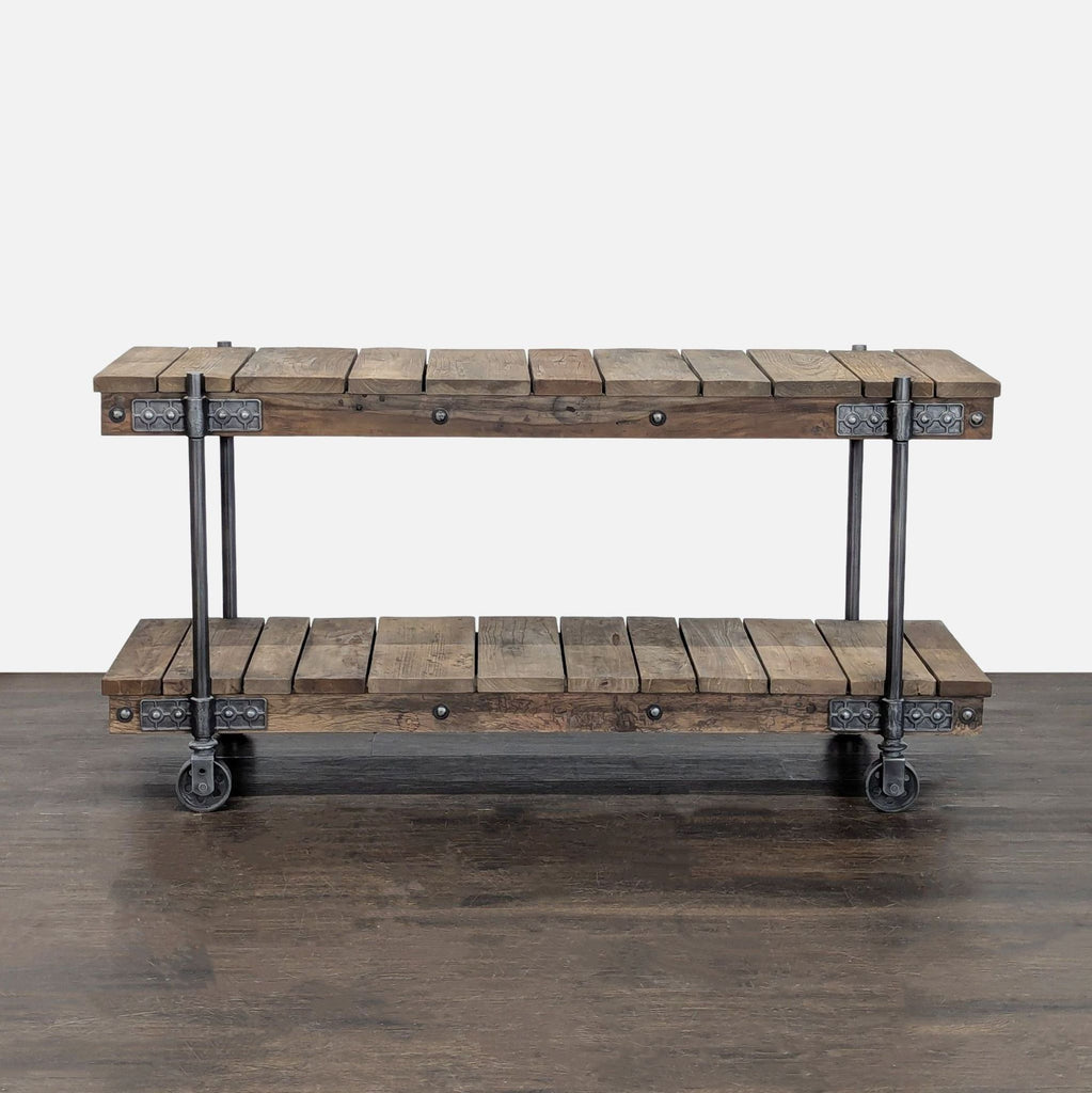 1. Pottery Barn console table with two wooden shelves, industrial metal frame, and caster wheels for mobility.  