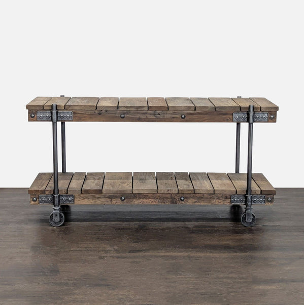 Pottery Barn industrial console made of reclaimed wood with dark iron hardware, shown against a neutral wall.  