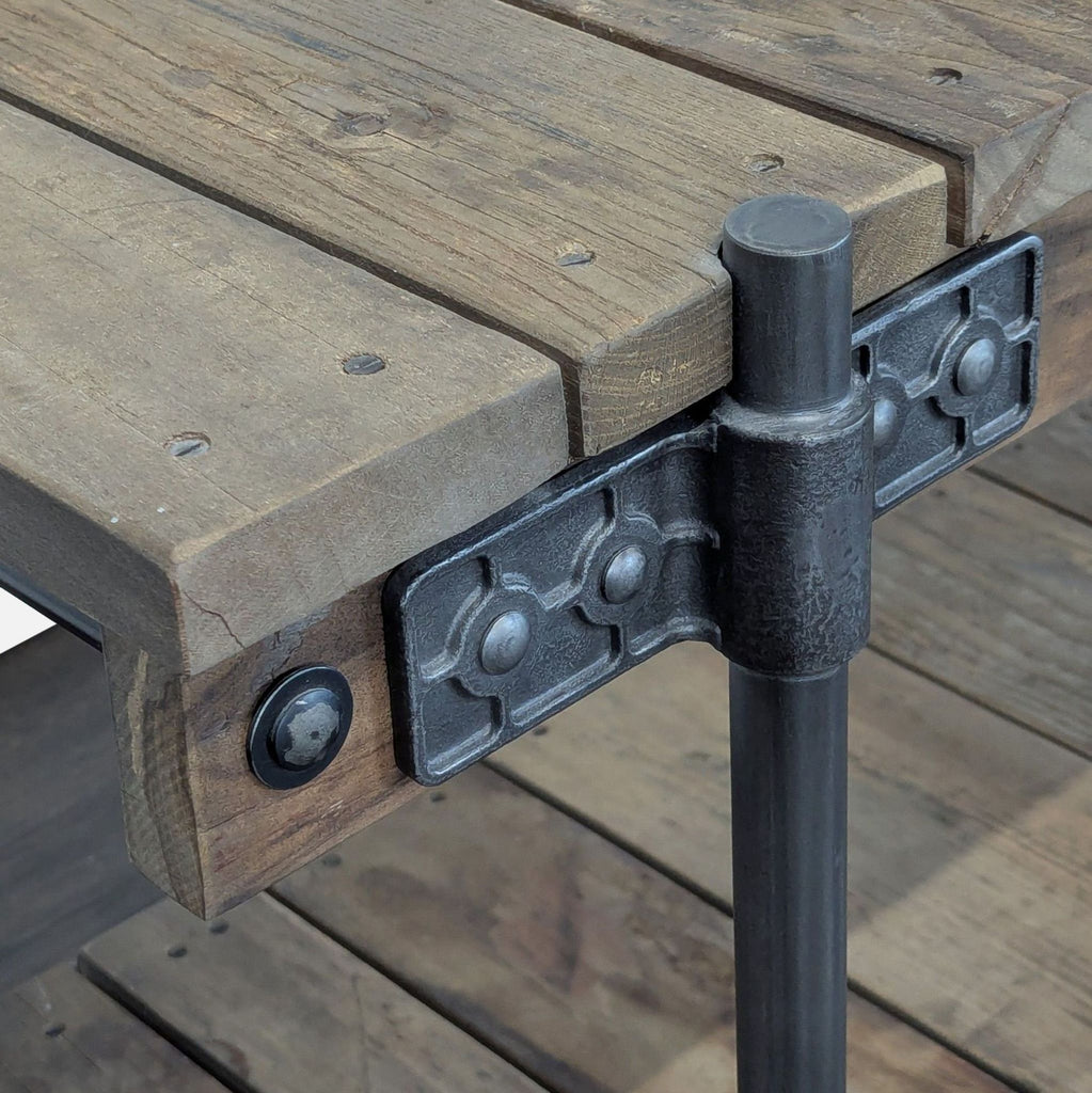 Reclaimed wood console table by Pottery Barn featuring exposed iron fittings for an industrial look.  