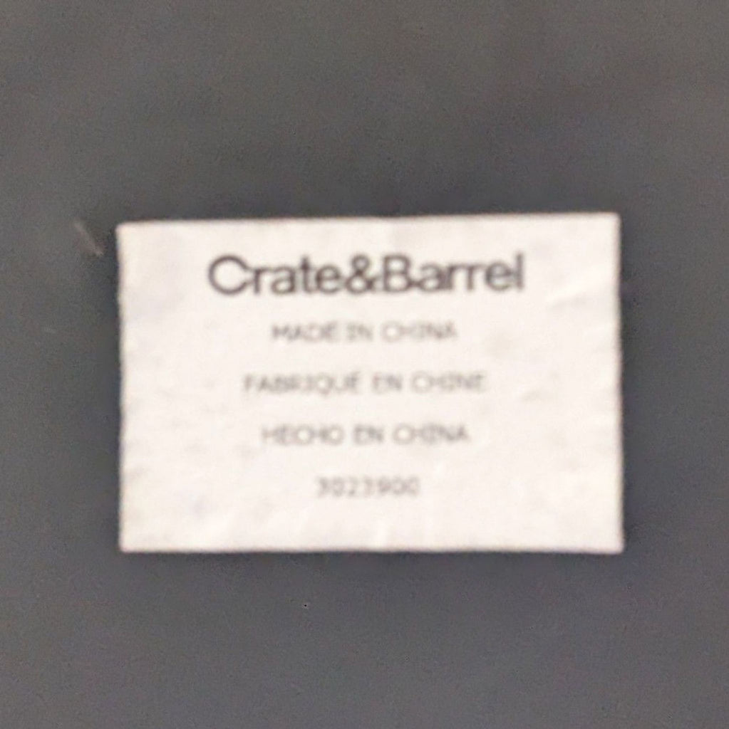 2. Close-up of Crate & Barrel brand label stating "Made in China" on the underside of a table.