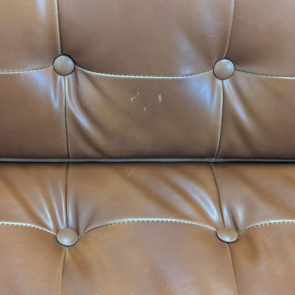 3. Detailed shot of button-tufted brown leather seat and back cushions of an HD Buttercup 3-seat sofa.