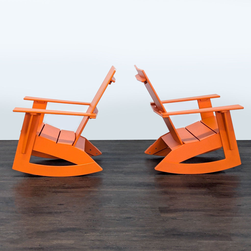 Set of two orange rocking chairs and a matching round coffee table by Room & Board, designed for patios or balconies.