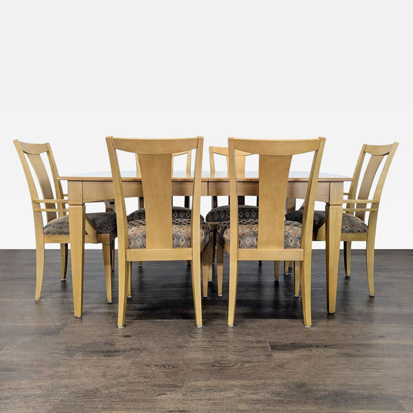 Ethan Allen 7-piece dining set with light wood table and six upholstered chairs arranged for dining.