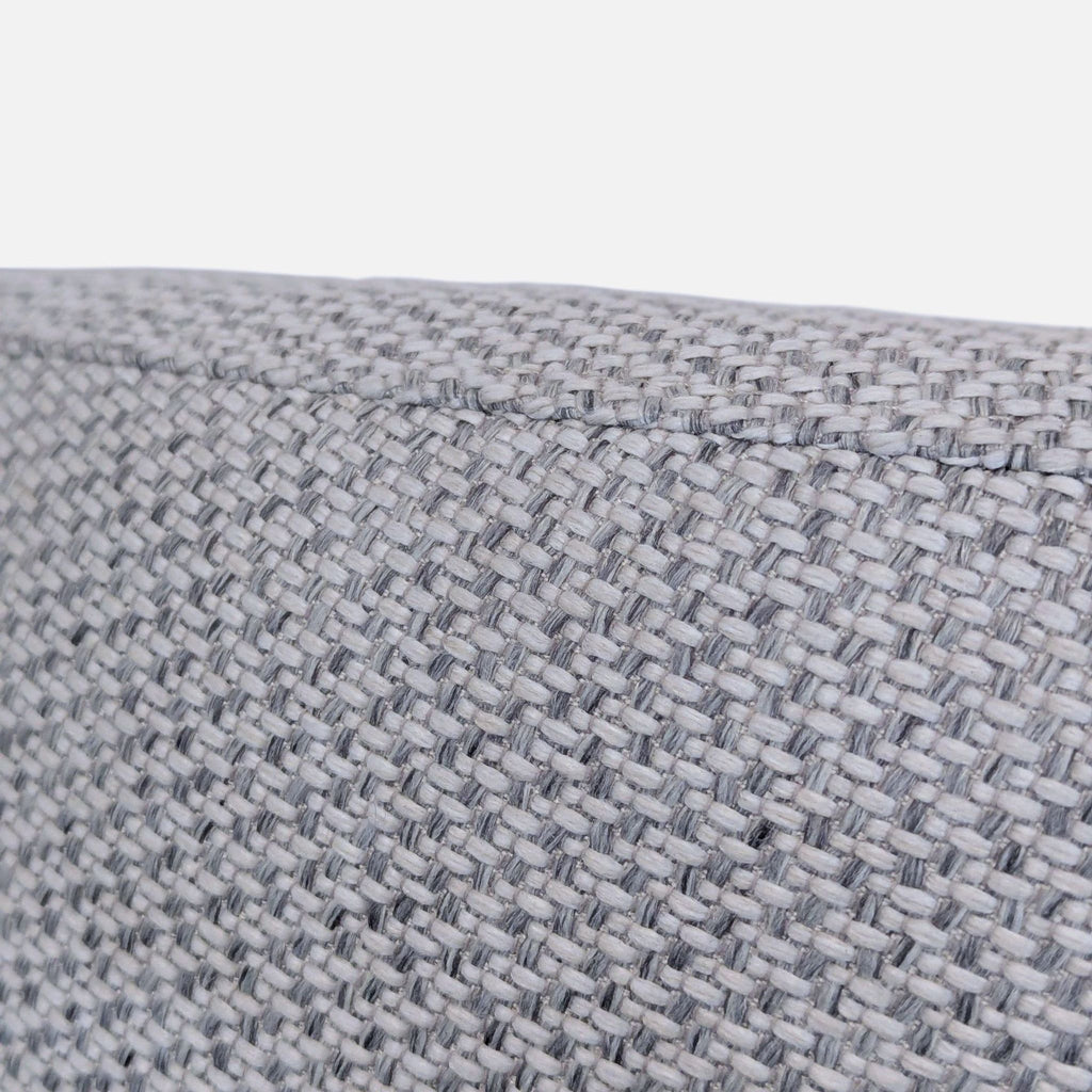 Comfortable, stylish lounge chair in light grey fabric with a roomy, modern, rounded shape for home interiors.