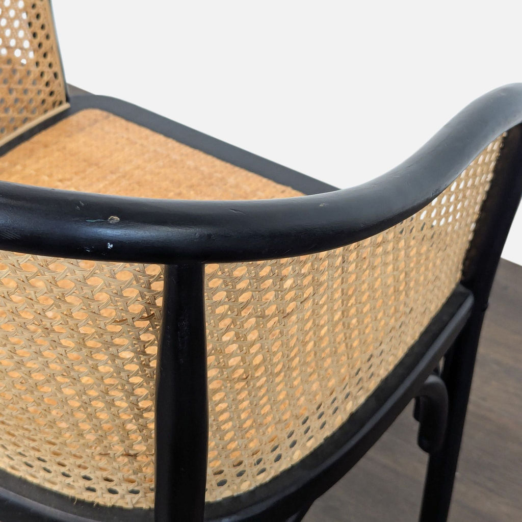 Dining chair featuring solid beech wood construction and a woven rattan seat, by Pottery Barn.  