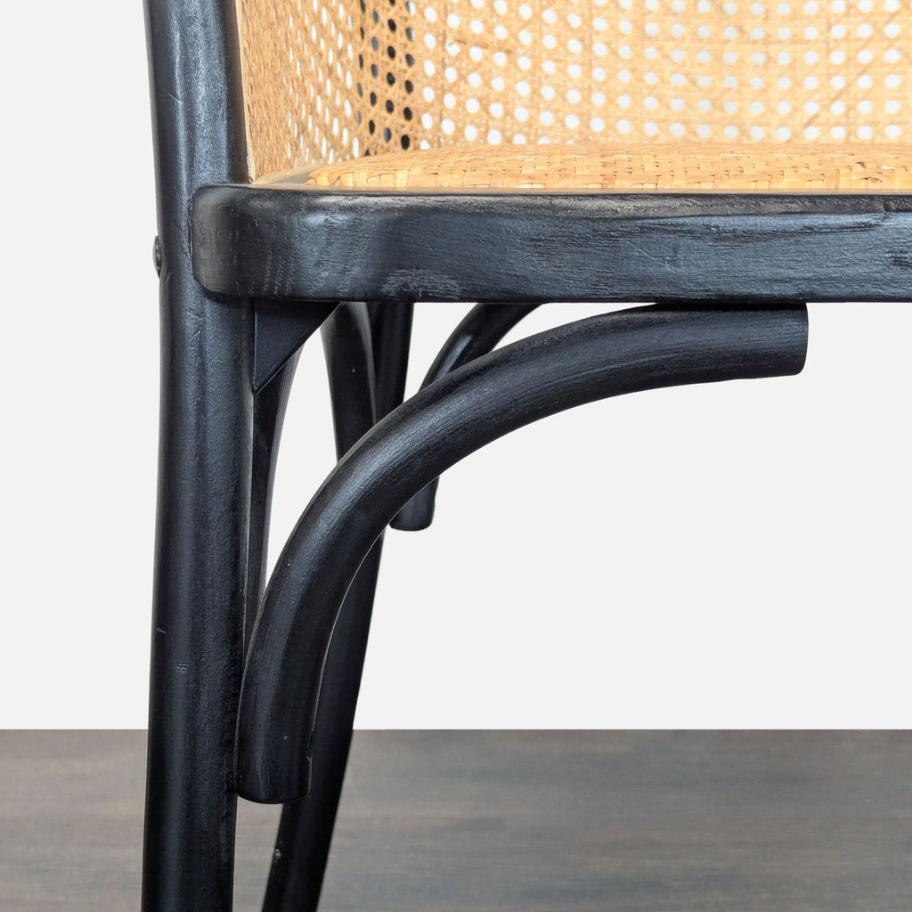 Wooden dining chair with natural rattan seat, in Pottery Barn's signature style.