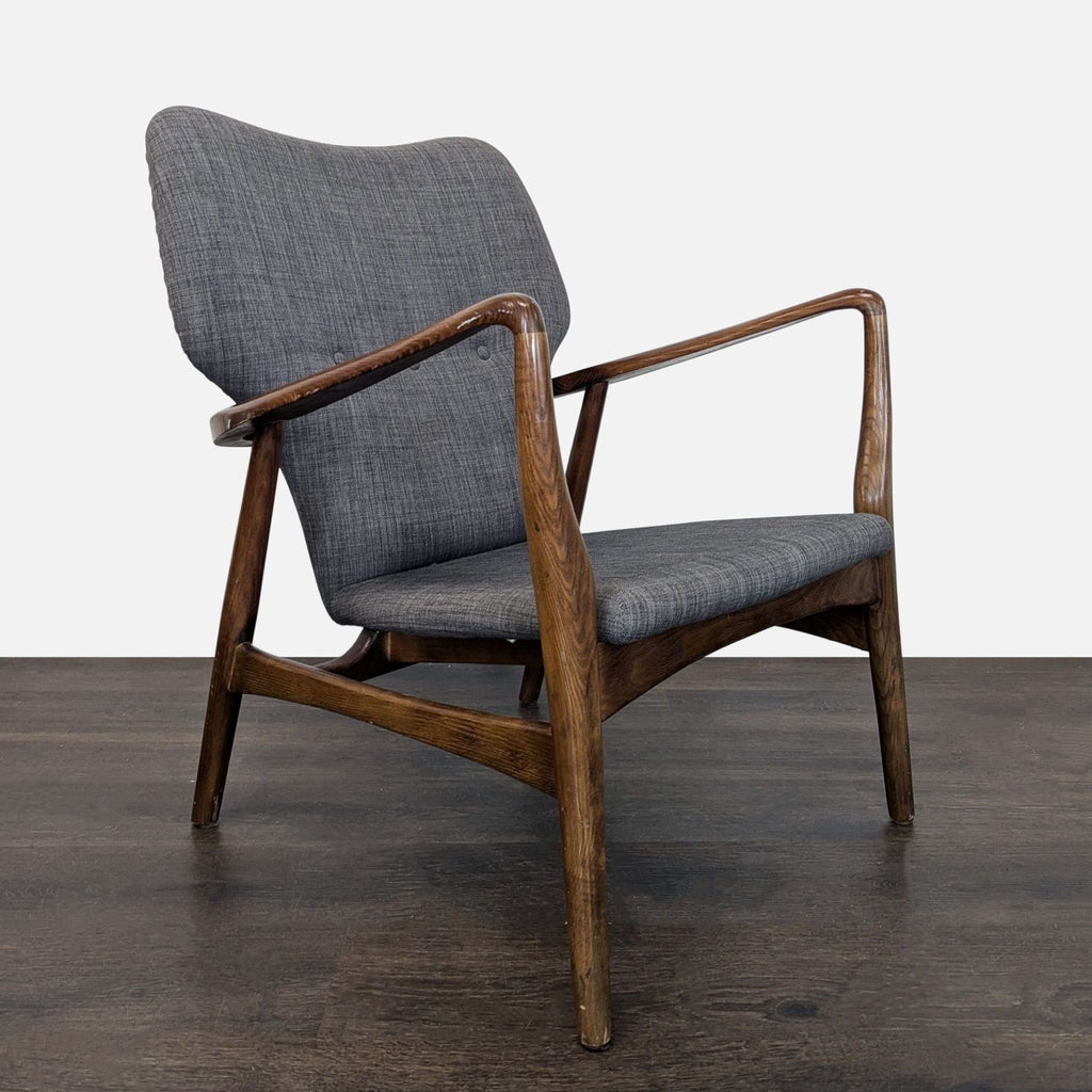 Grey upholstered lounge chair with retro design and sturdy wood frame, ideal for elegant lounge spaces.