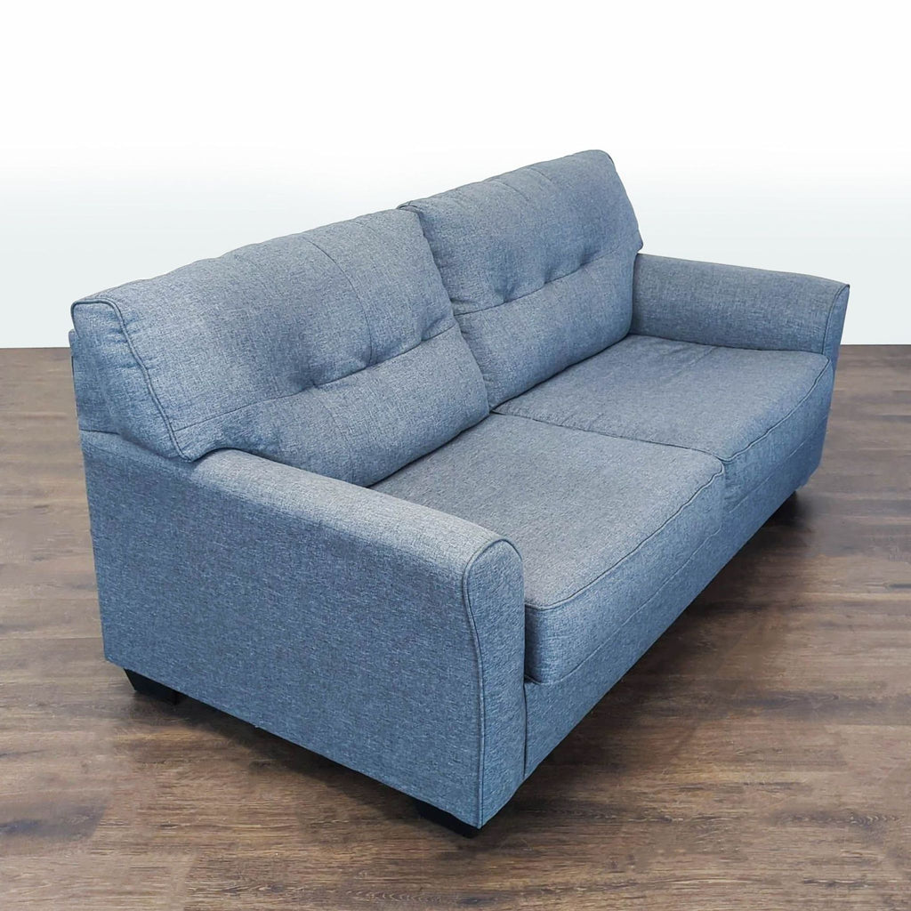 2. Angled side view showing the blue 3-seat Ashley Furniture sofa with plush cushions and sturdy armrests.