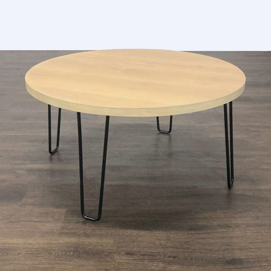Rectangular wooden coffee table with slim wire hairpin legs, combining natural and industrial styles.