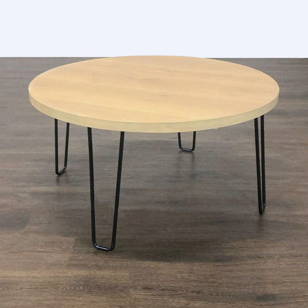 Rectangular wooden coffee table with slim wire hairpin legs, combining natural and industrial styles.