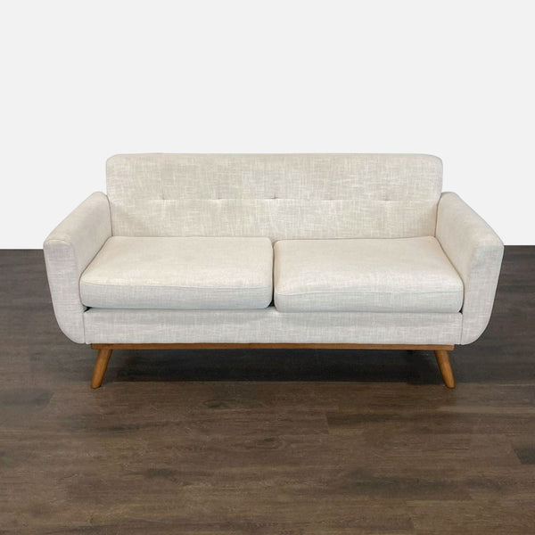Light gray upholstered loveseat with wooden legs, modern design, and cushioned seating for two.