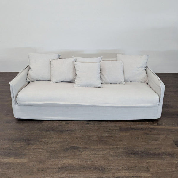 Modern 3-seat sofa with light fabric, removable cushions, and wide arms, ideal for contemporary living rooms.