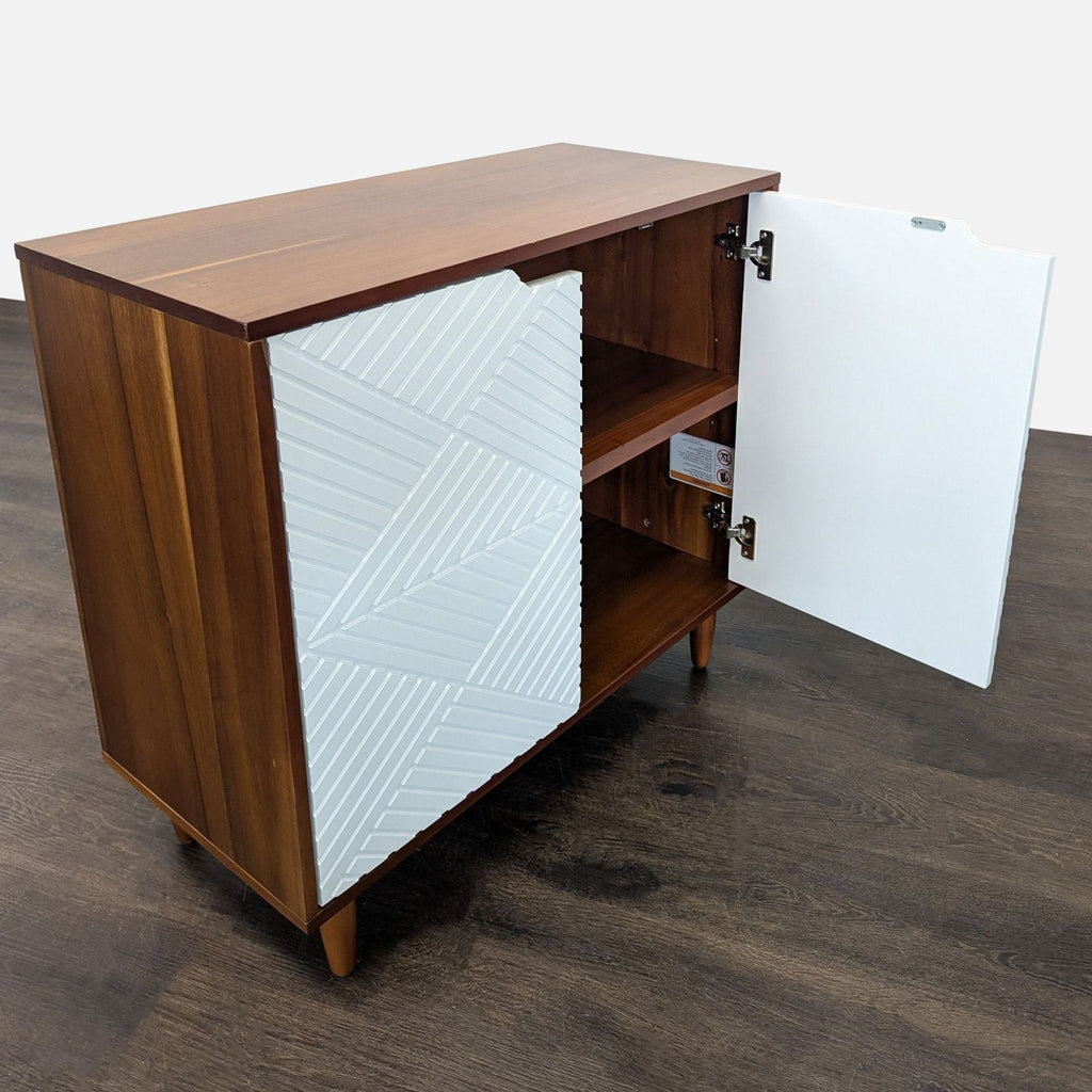 Geometric white-door West Elm cabinet with wood finish and dual interior storage shelves.