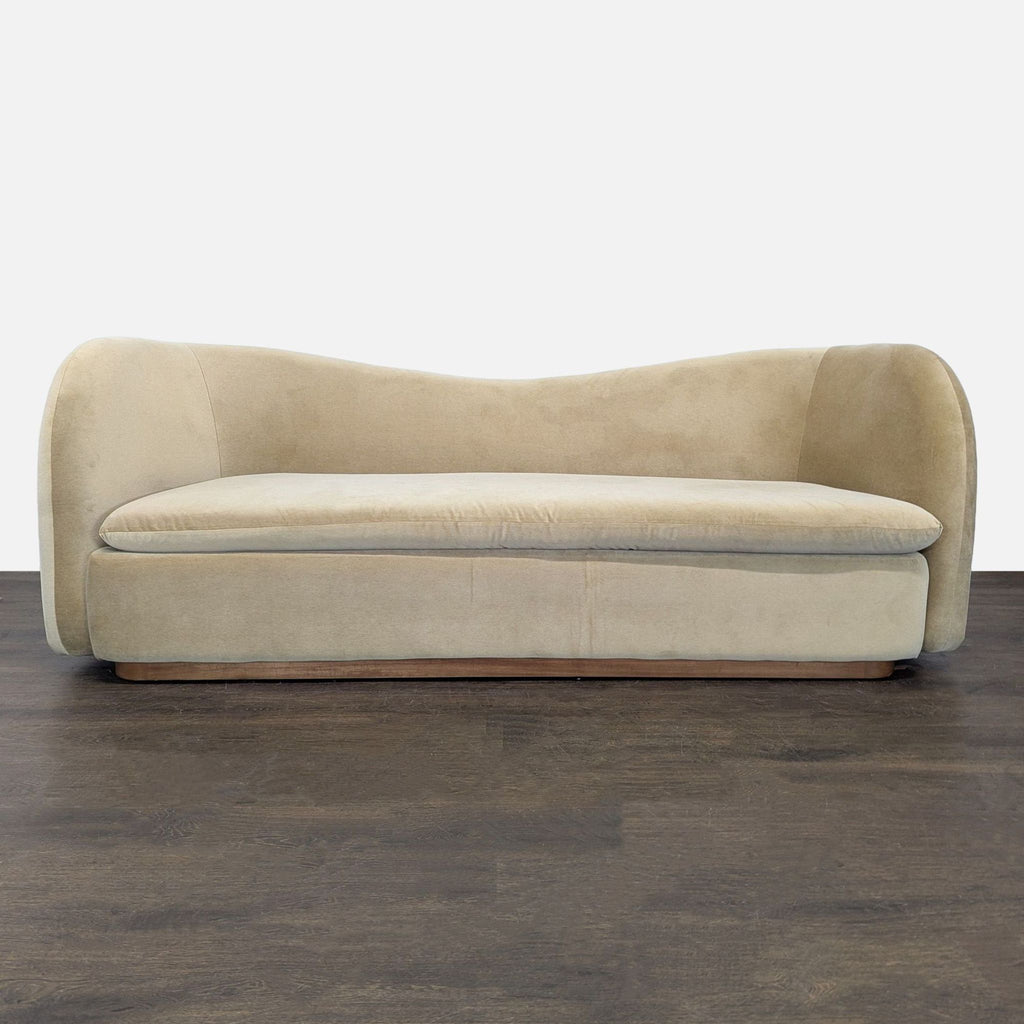 West Elm 3-seat sofa with curved modern design and beige upholstery, ideal for stylish living rooms.