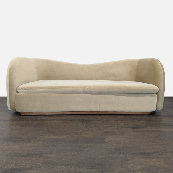 West Elm 3-seat sofa with curved modern design and beige upholstery, ideal for stylish living rooms.