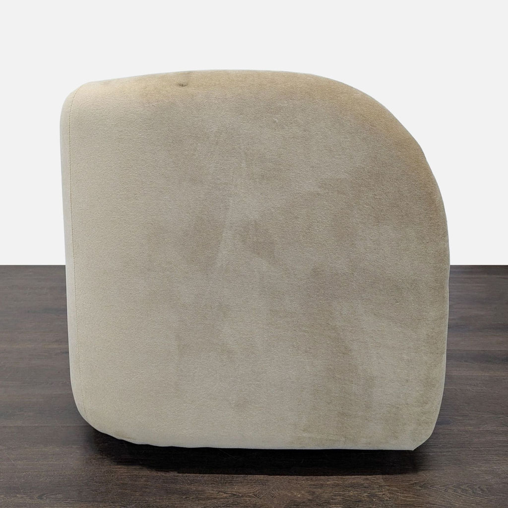 Curved West Elm sofa in soft beige, offering spacious seating and a supportive backrest for comfort.