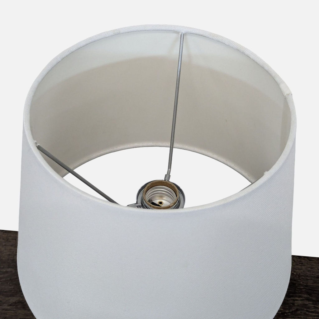 Contemporary lamp with minimalist clear base and white shade, ideal for any room decor.