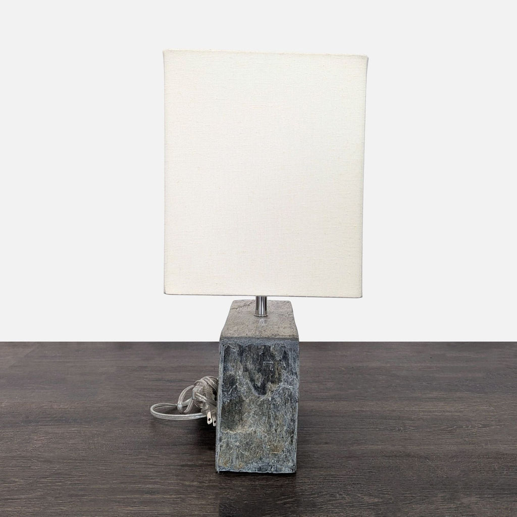 Elegant lamp featuring a natural stone base and simple white shade, perfect for bedside or accent lighting.  
