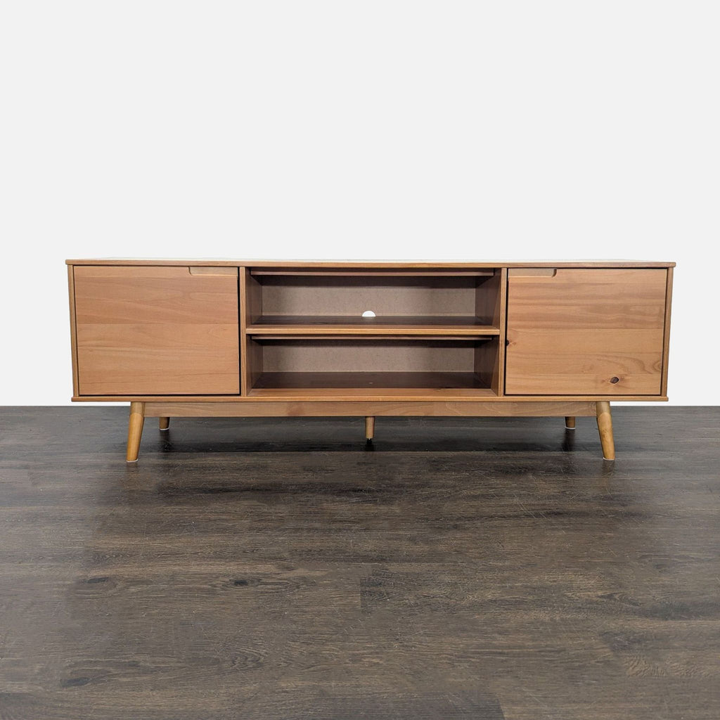 Mid-century modern media console with warm wood finish, two cabinets, four open shelves, and cable management hole.