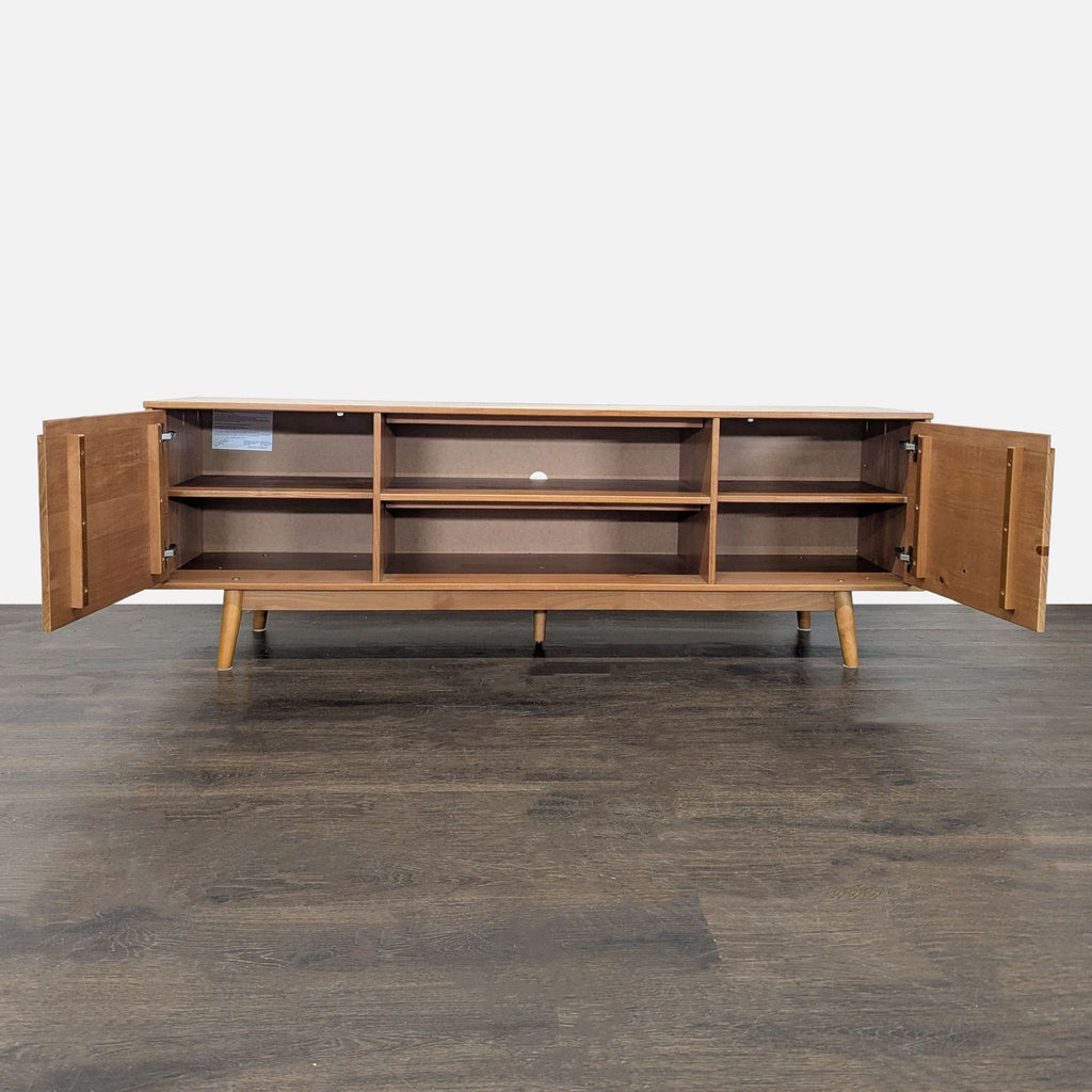 Entertainment center in wood with dual door cabinets, four open storage spaces, and rear cable management opening.
