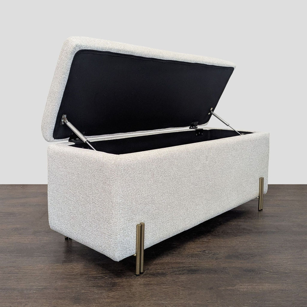 Modern bench with adjustable brass legs and gas-lift seat for storage, from West Elm's collection.