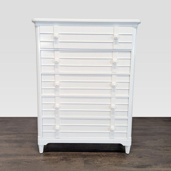 White Stanley Furniture dresser with five drawers and decorative knobs for bedroom storage.