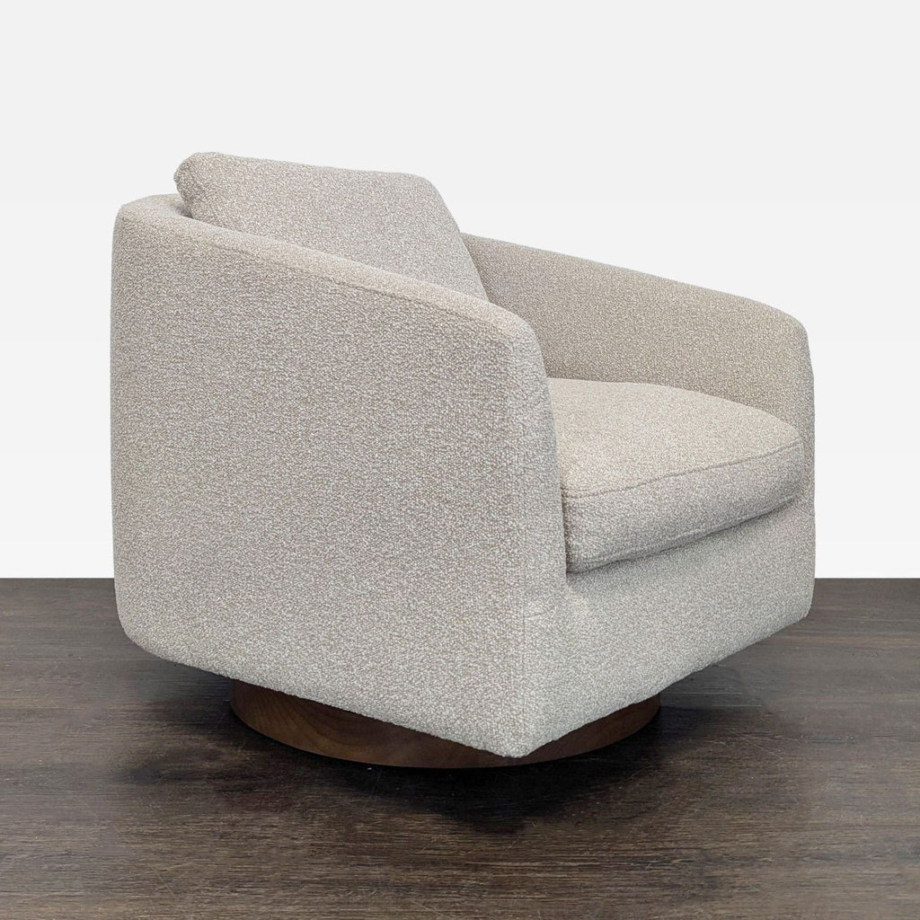 Modern beige West Elm swivel lounge chair with a thick cushion and supportive back, ideal for relaxing spaces.