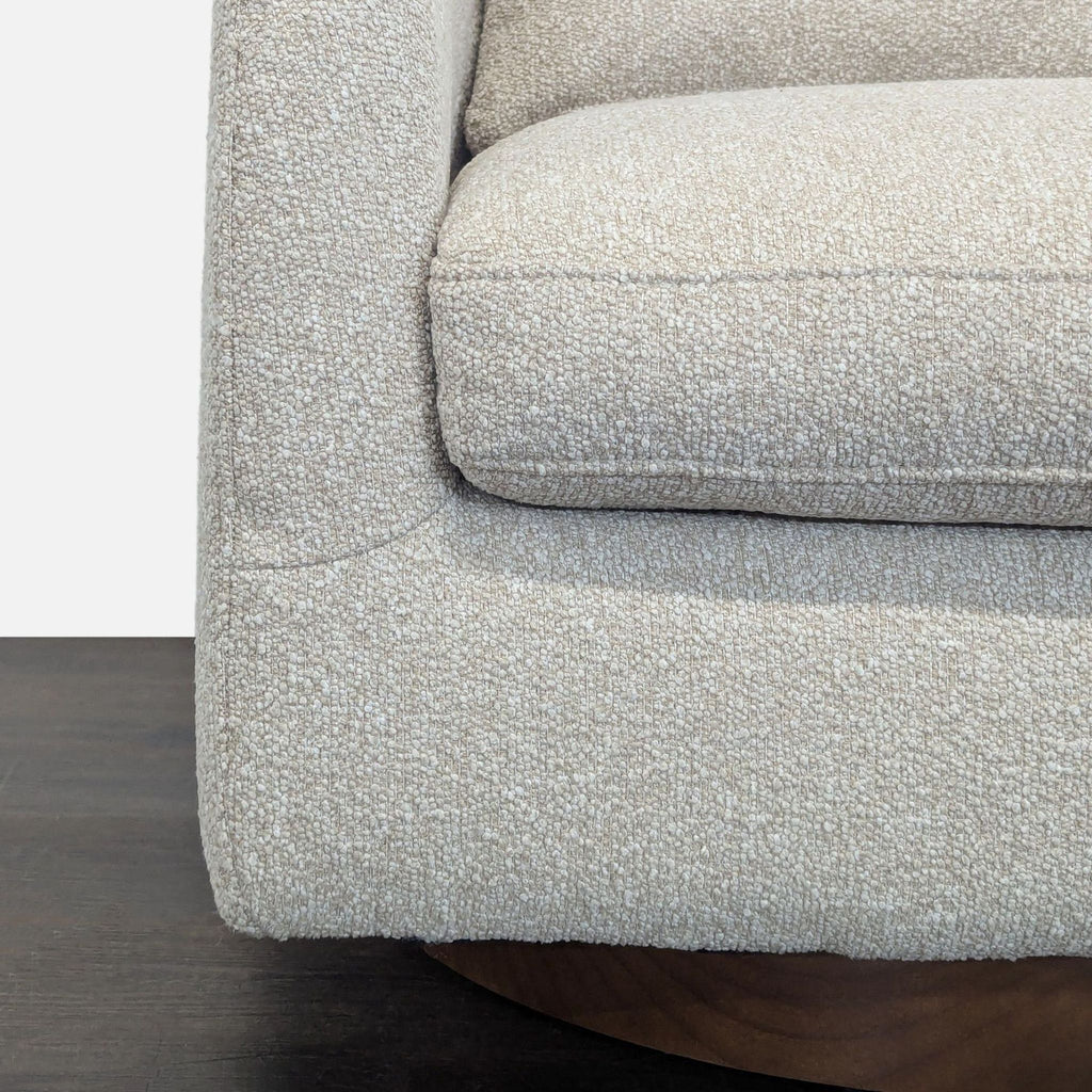 Textured beige West Elm lounge chair, compact with a sturdy swivel base, complements various living room decors.