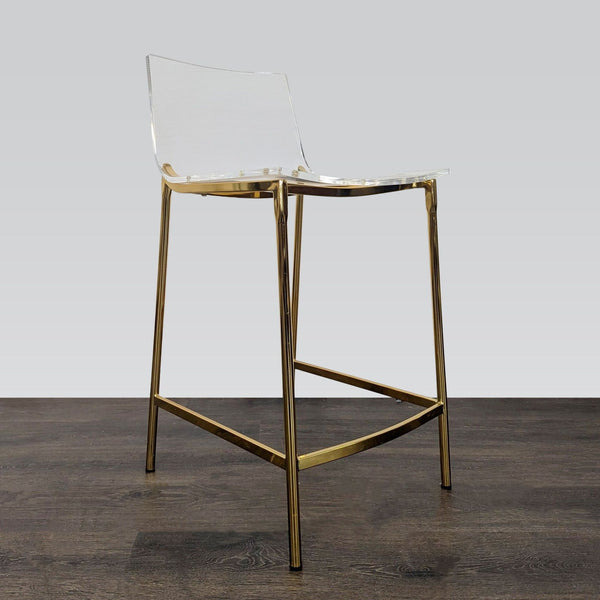 Clear acrylic stool with gold metal legs, stylish and modern, from CB2’s Stools, Ottomans & Benches collection.  