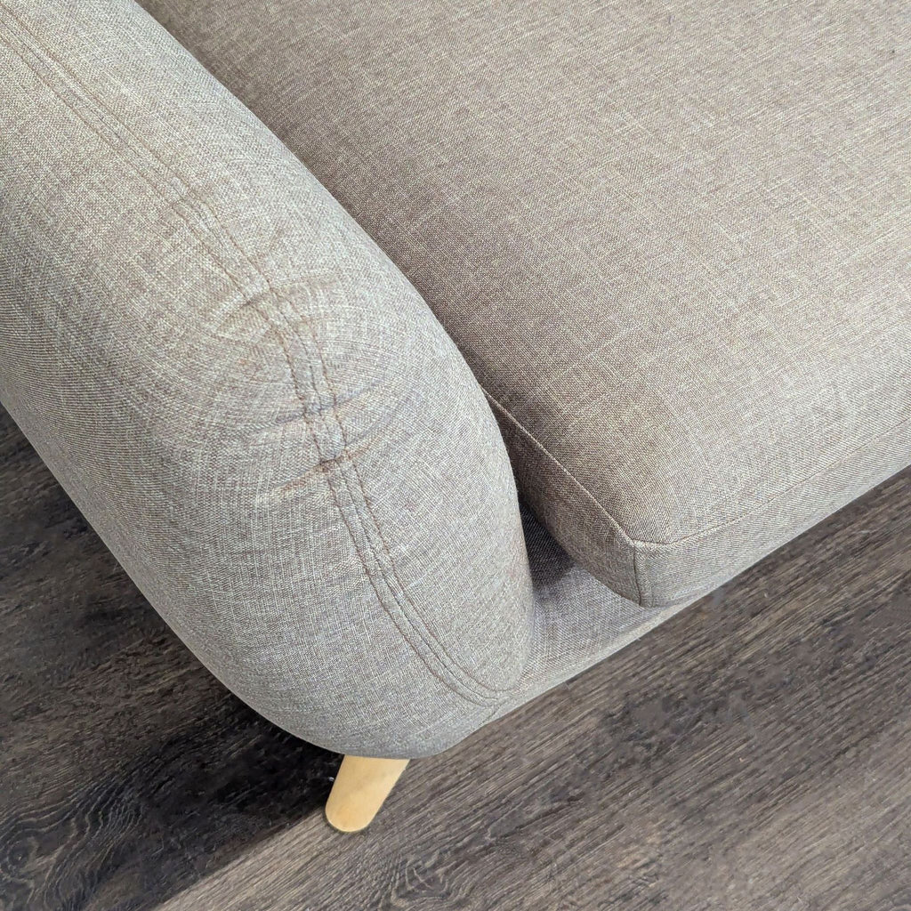 Cozy beige loveseat by Modway with curved arms, angled wood legs, and a soft, tufted backrest.