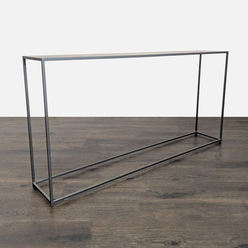 CB2 side table featuring a slender, metallic build suitable for contemporary home décor.