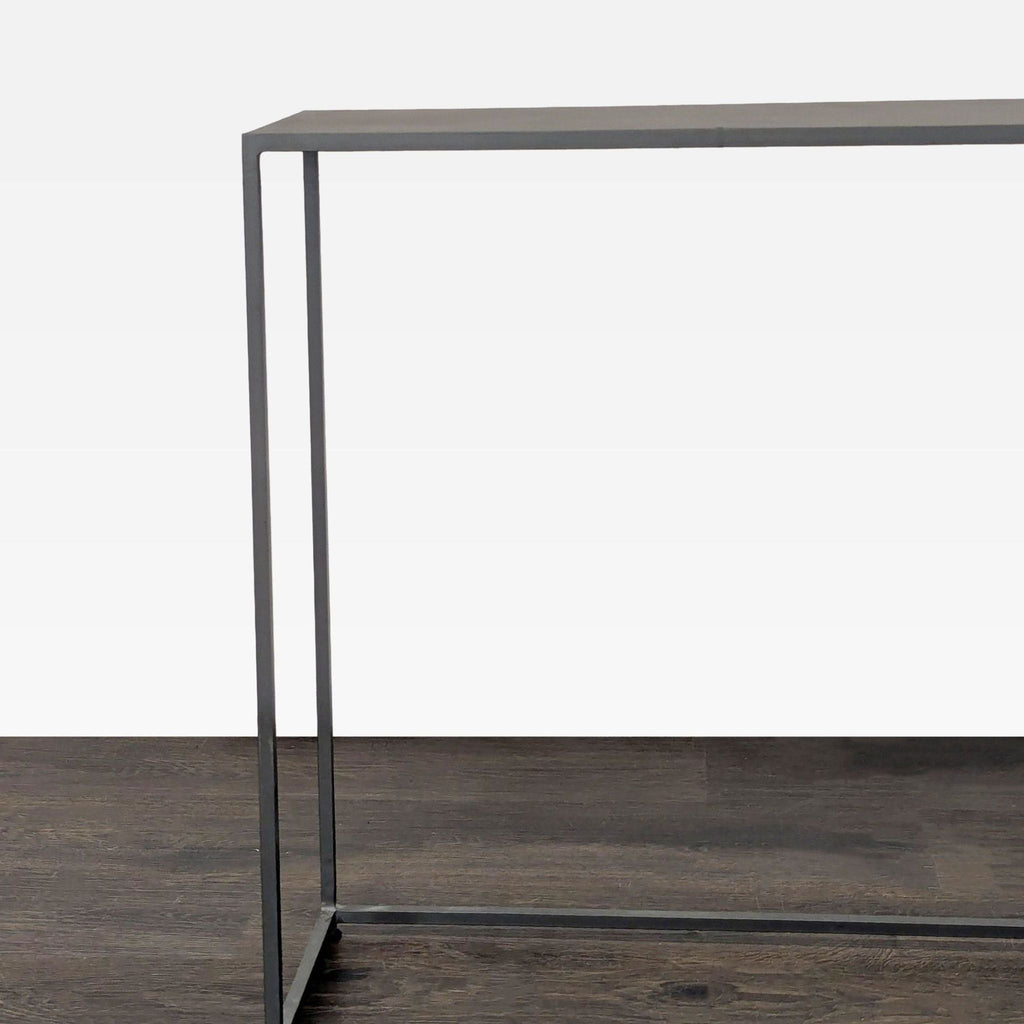 Minimalist all-metal console table by CB2, designed for compact living spaces.  