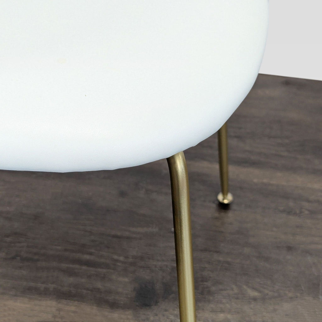 Elegant mid-century dining chair; plush seat, arched backrest, sturdy metal legs; from Dining Chairs category.