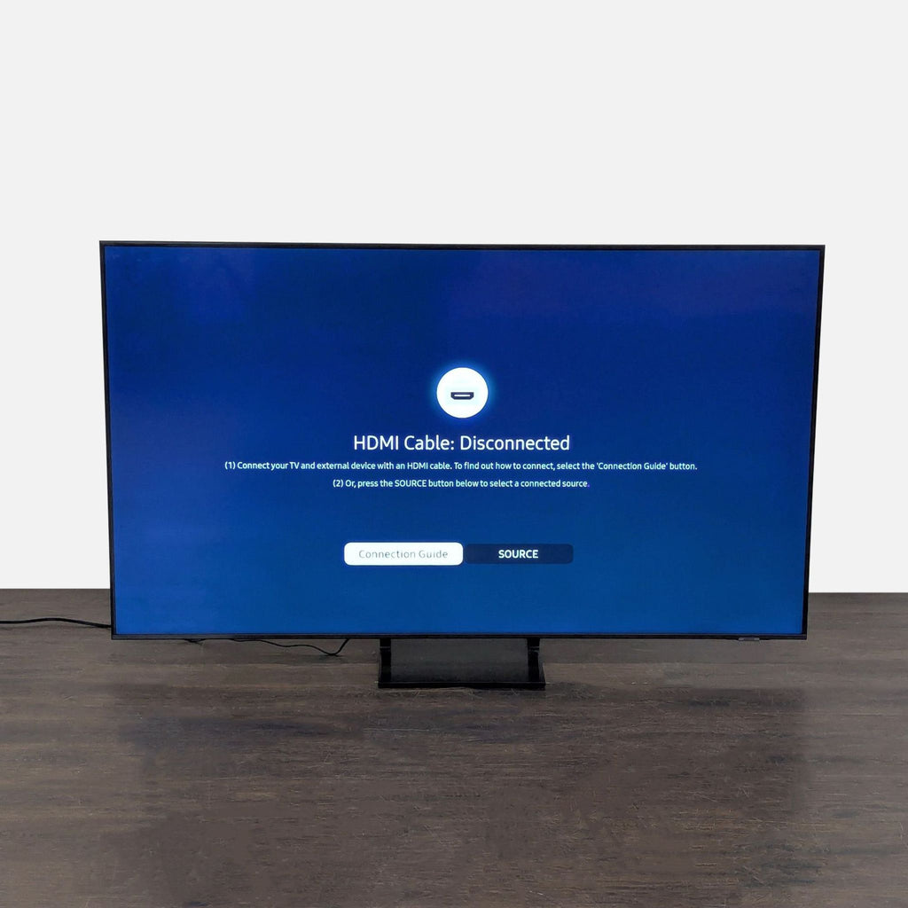 Large Samsung LED Smart TV with clear display, sturdy base; supports HDMI and smart features.