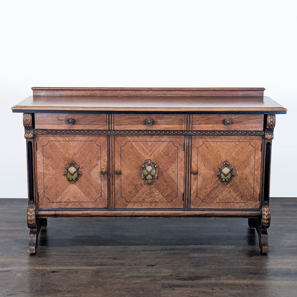 Classic sideboard with carved details, three drawers, and three cabinet doors with decorative medallions.