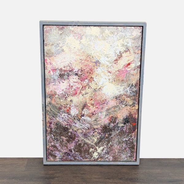 Abstract painting with pink, cream, and earthy tones in a worn gray frame, showing rich texture.