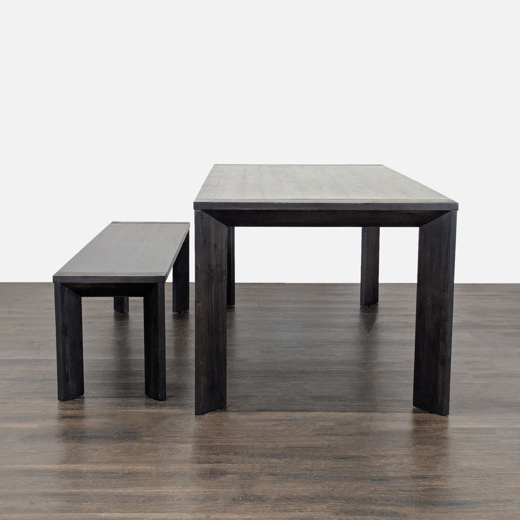 Dining set by Living Spaces featuring a sleek table, four cushioned grey chairs, and a coordinating wooden bench.