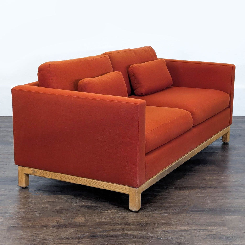 1. Modern gray fabric loveseat with tufted cushions and wooden legs, seating two people.