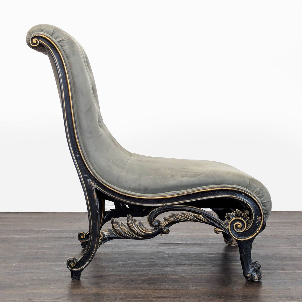 Classic lounge chair with wide curved seat, gray tufting, and decorative black legs with gold accents.