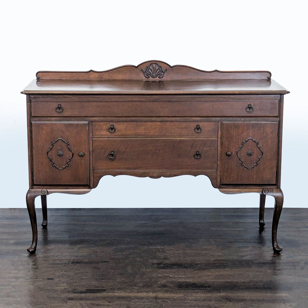 Classic wooden sideboard with carved accents, cabriole legs, two cabinets, and three drawers.  