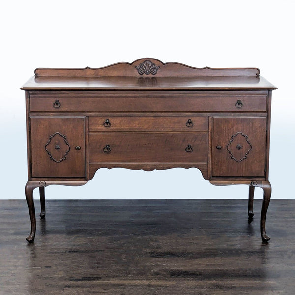 Classic wooden sideboard with carved accents, cabriole legs, two cabinets, and three drawers.  